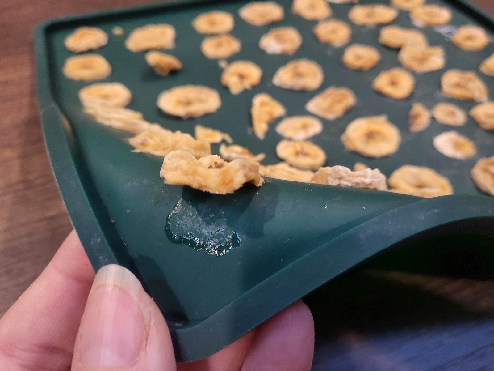 Close up of dried banana slices easily coming off a silicone mat