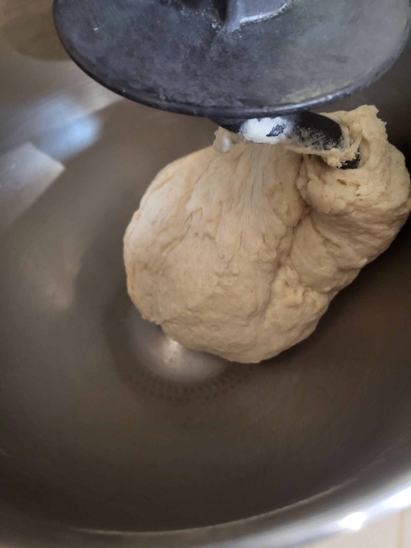 Tortilla dough on the dough hook of a stand mixer