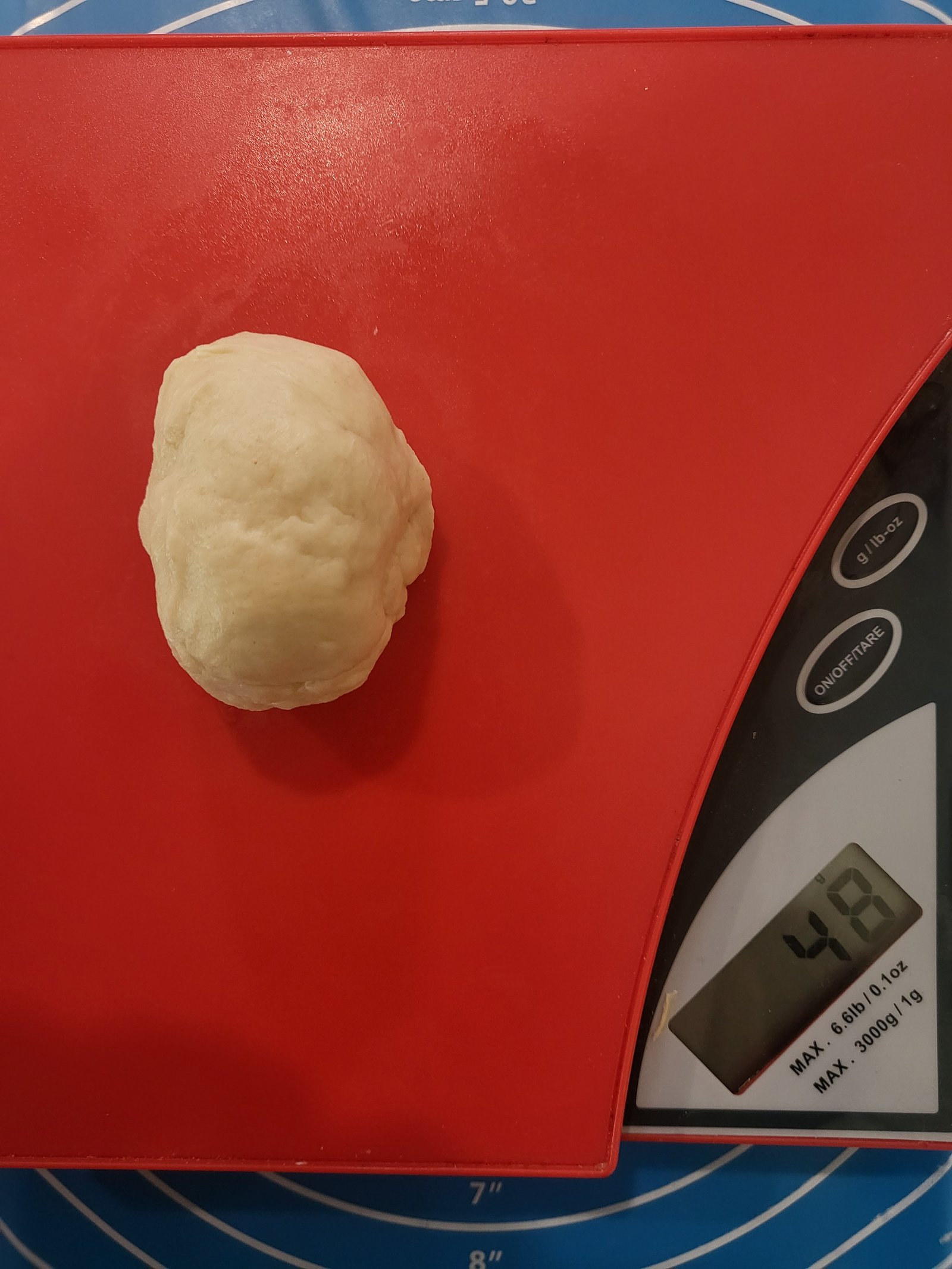 ball of flour tortilla dough on a kitchen scale