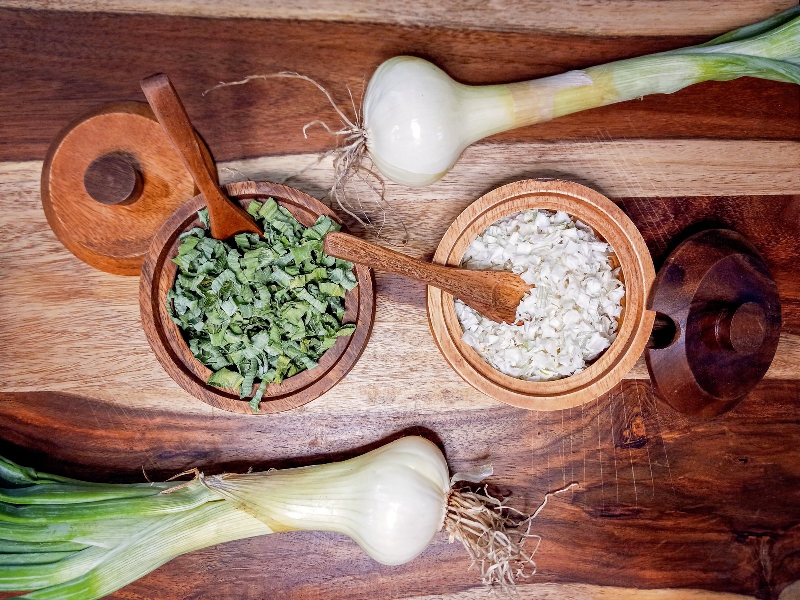 Dehydrated onions in wood bowls on a cutting board