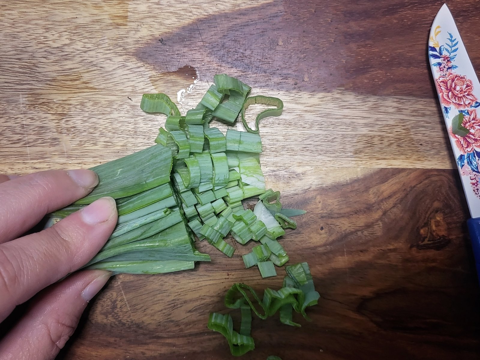 green onion tops being sliced