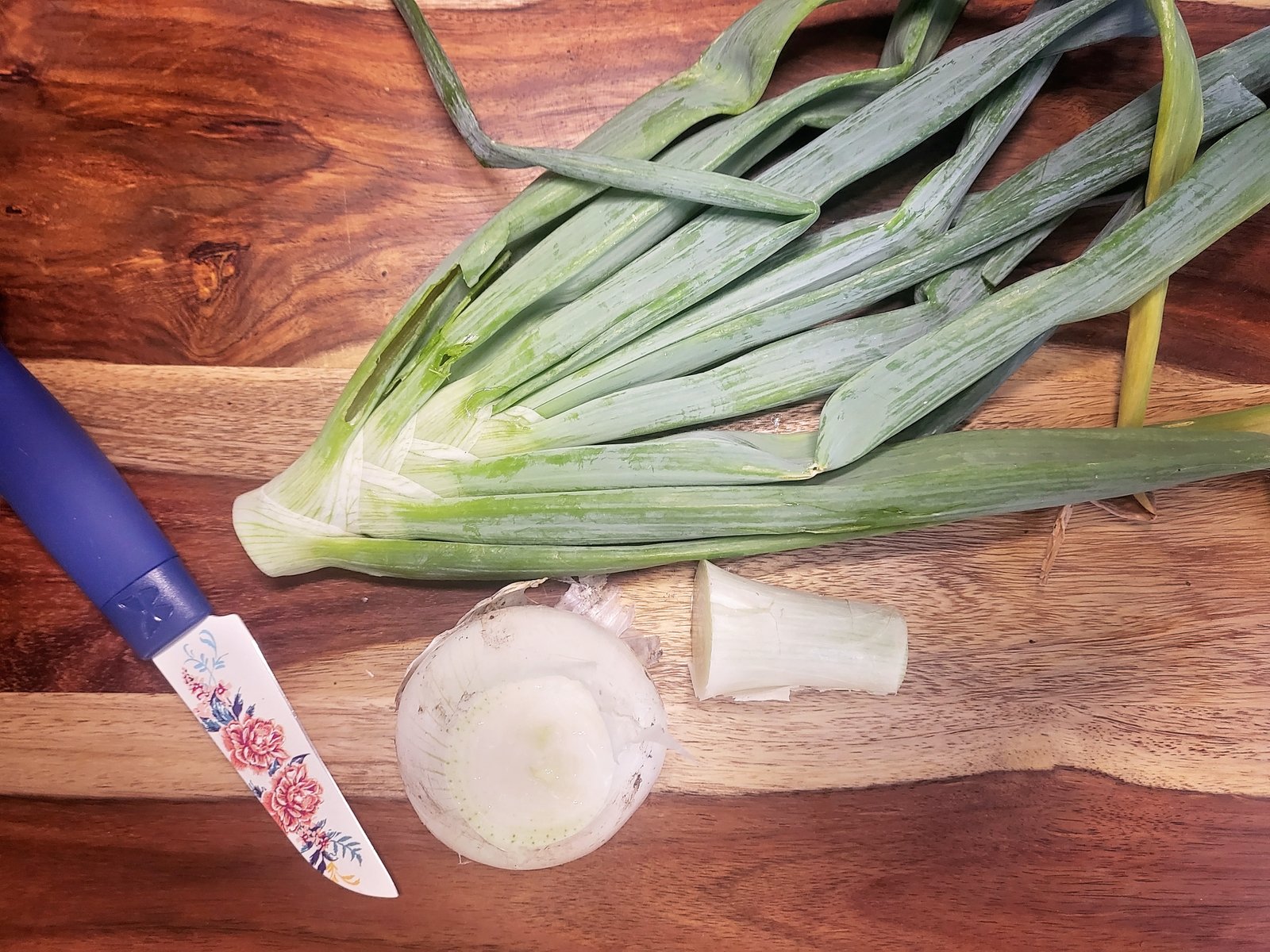 onion tops with a cleaned onion ready to be chopped